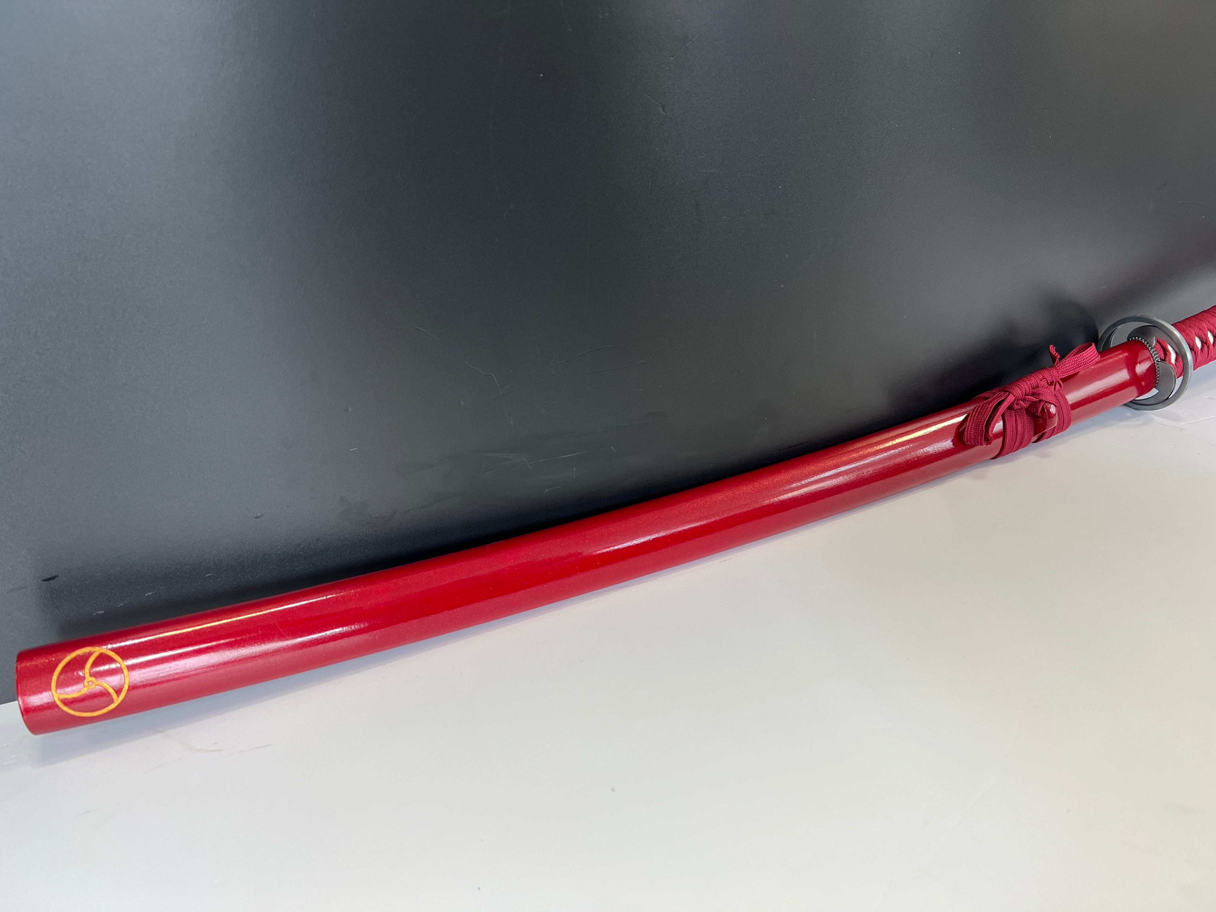 Katana in red with the seal of heaven (tomoe)